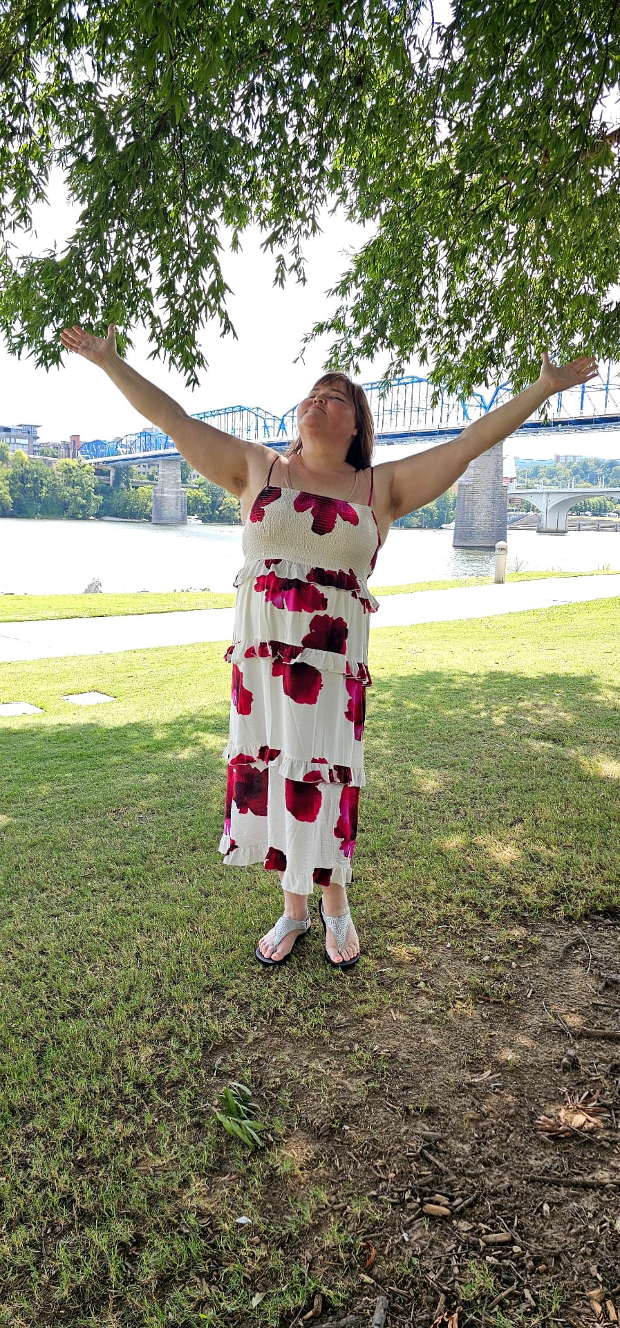 Myra with her arms lifted to the sky