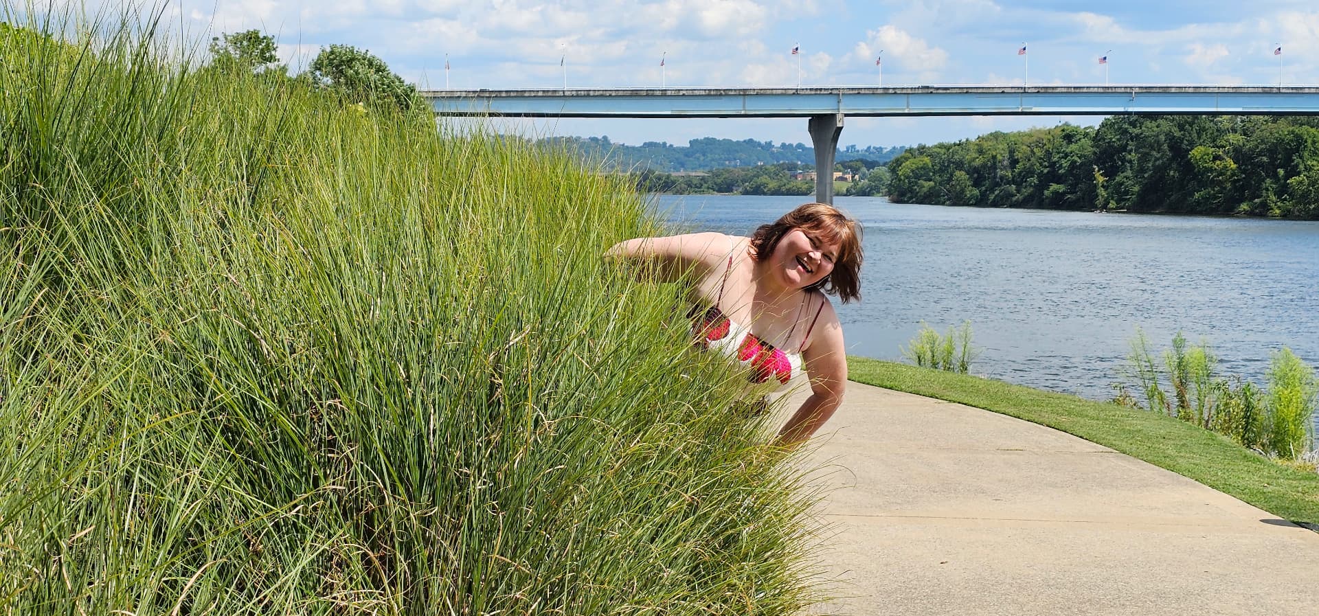 Myra peeking playfully through the river grass
